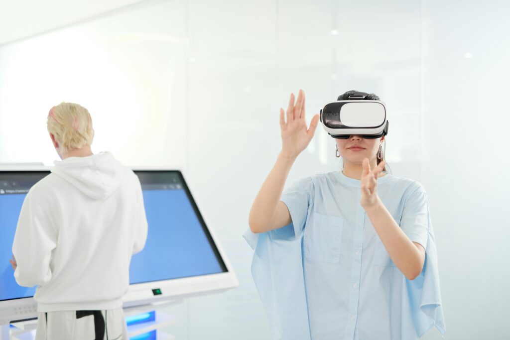 pexels-photo-4384669-4384669 Woman exploring virtual reality with VR goggles in a modern technological environment.